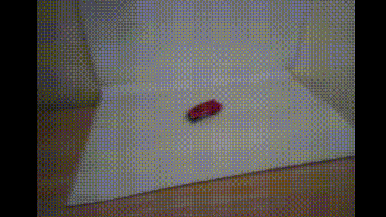 GIF demonstrating the working model on a red toy car